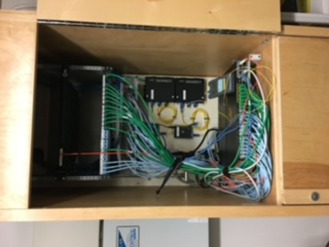 A cabinet with a bunch of wires coming out of it.