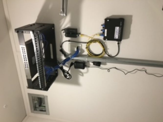 A rack with a bunch of wires connected to it.