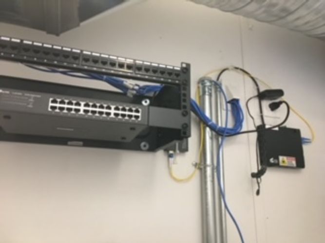 A server rack with a bunch of wires coming out of it.